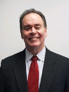 white man in suit with red tie